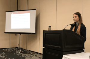 Miranda Berrigan at a podium presenting research