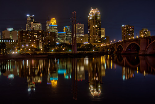 Photo of Minneapolis at night as reflected in the Mississippi